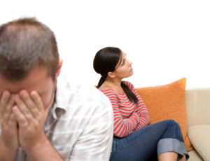 angry couple sitting on sofa